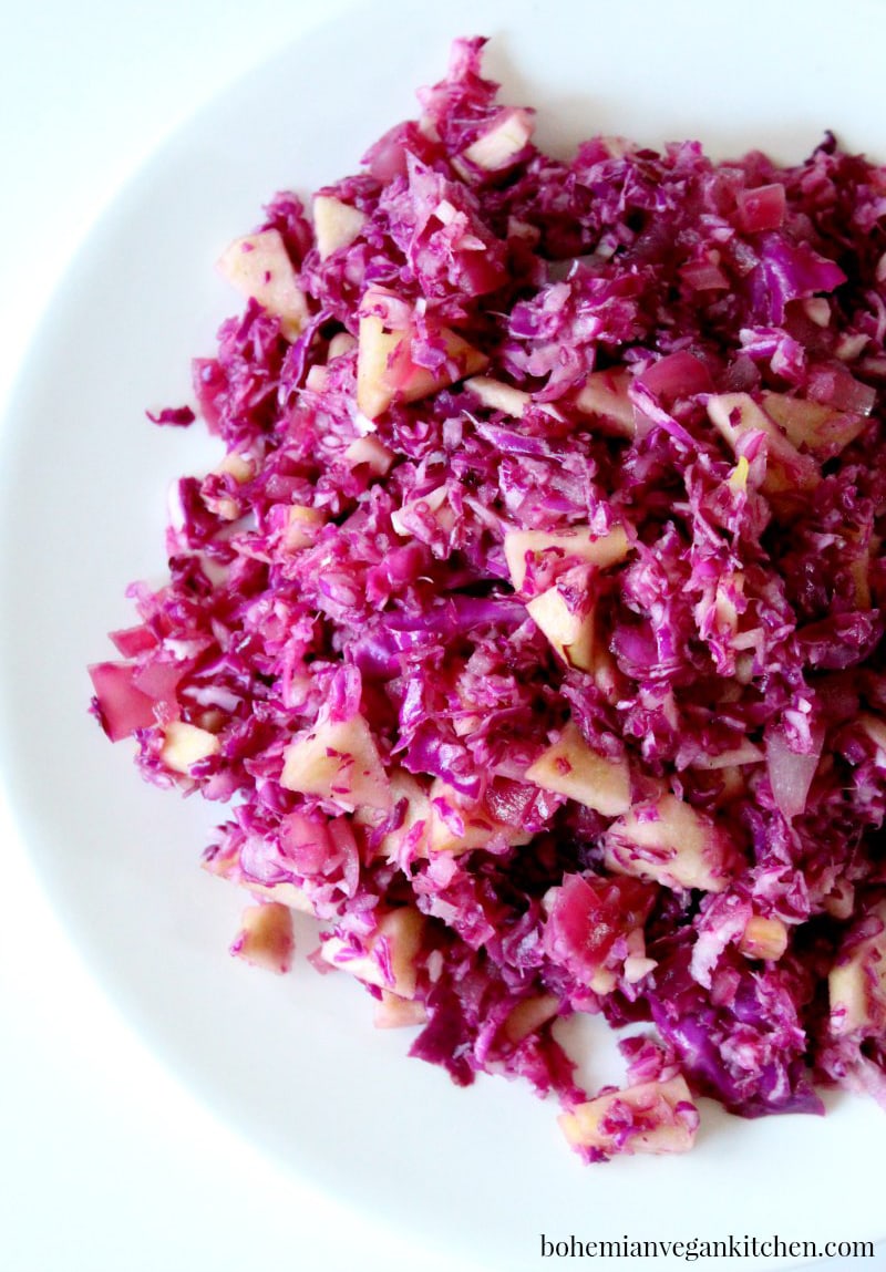 Enjoy a healthy serving of this gorgeous red cabbage and apples, complete with Balvarian influence, for a delicious vegan German experience. #vegangermanfood #vegangermanrecipes #vegangermanslaw #vegangermanredcabbage #bohemianvegankitchen