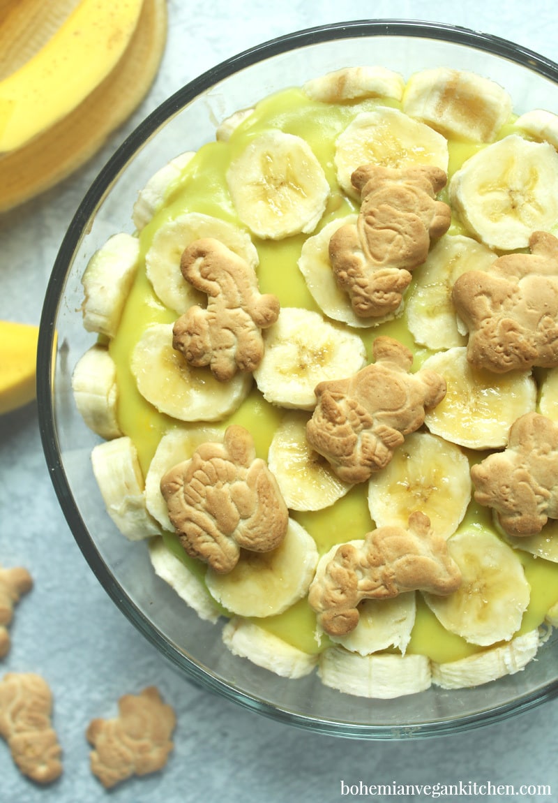 Dairy-free banana pudding is simple to pull together, but this version utilizes the natural sweetness of bananas and maple syrup as a healthy alternative to processed sugars, plus contains NO artificial coloring like traditional boxed banana pudding. Make it gluten-free (and 100% cruelty-free!) by using gluten-free + vegan animal crackers instead of traditional vanilla wafers. #dairyfreebananapudding #dairyfreebananapuddingmaplesyrup #veganbananapudding #veganbananapuddingrecipe #veganbananapuddinghealthy #bohemianvegankitchen