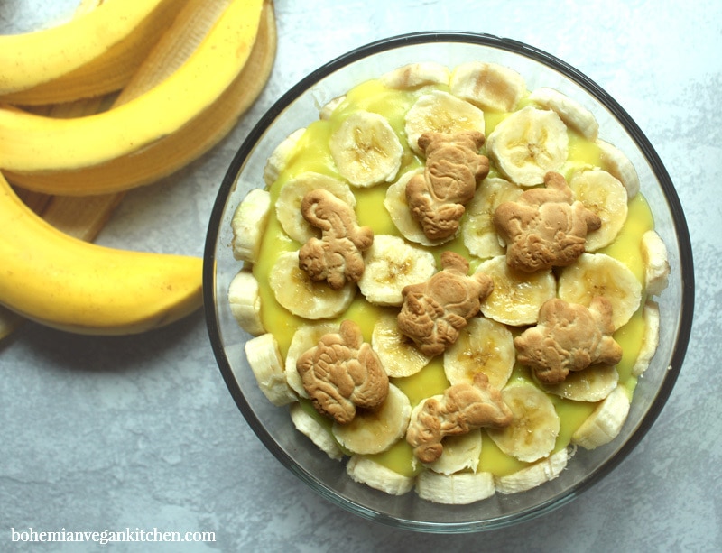 Dairy-free banana pudding is simple to pull together, but this version utilizes the natural sweetness of bananas and maple syrup as a healthy alternative to processed sugars, plus contains NO artificial coloring like traditional boxed banana pudding. Make it gluten-free (and 100% cruelty-free!) by using gluten-free + vegan animal crackers instead of traditional vanilla wafers. #dairyfreebananapudding #dairyfreebananapuddingmaplesyrup #veganbananapudding #veganbananapuddingrecipe #veganbananapuddinghealthy #bohemianvegankitchen