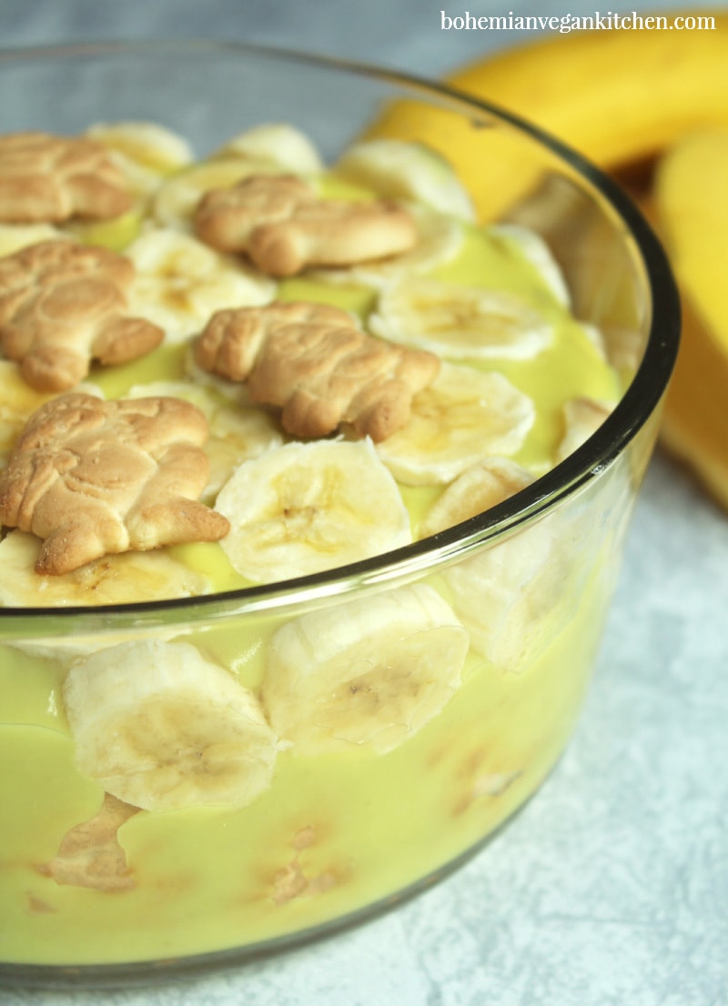 Dairy-free banana pudding is simple to pull together, but this version utilizes the natural sweetness of bananas and maple syrup as a healthy alternative to processed sugars, plus contains NO artificial coloring like traditional boxed banana pudding. Make it gluten-free (and 100% cruelty-free!) by using gluten-free + vegan animal crackers instead of traditional vanilla wafers. #dairyfreebananapudding #dairyfreebananapuddingmaplesyrup #veganbananapudding #veganbananapuddingrecipe #veganbananapuddinghealthy #bohemianvegankitchen