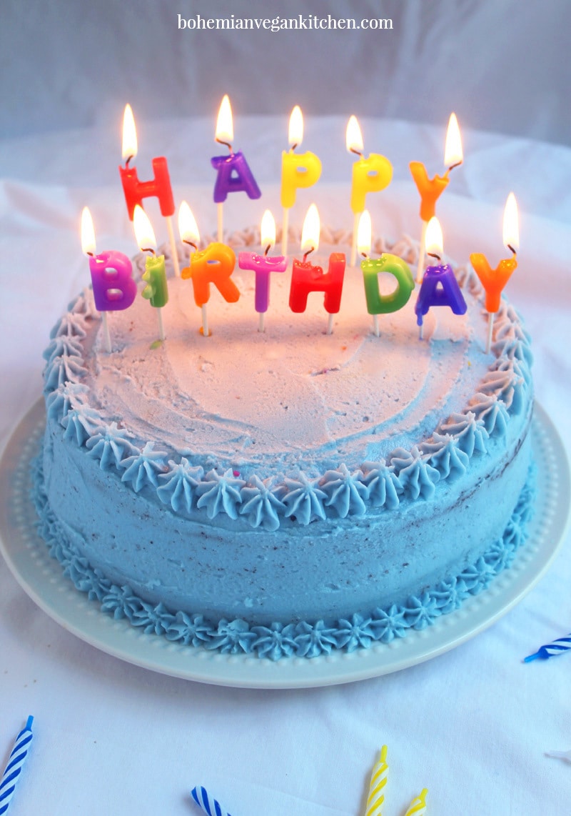 picture of allergen free birthday cake with happy birthday candles lit on top. 