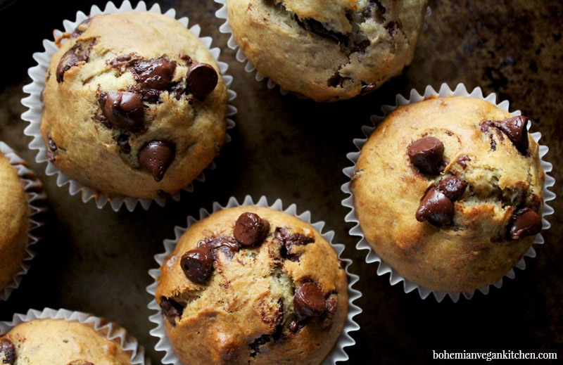 4 vegan banana chocolate chip muffins on a tray