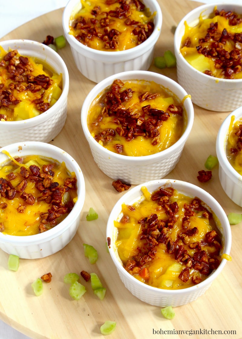 It's easy to become obsessed with this vegan baked potato soup, which is loaded down with melty dairy-free cheese and healthy homemade bacon bits! A snap to make, this soup is perfect for families and soup addicts, as each person gets their very own ramekin. Naturally vegan, this soup is meat-free, dairy-free, egg-free, and gluten-free. #veganbakedpotatosoup #veganbakedpotatosoupdairyfree #veganpotatosoup #veganpotatosoupeasy #veganbakedpotatosouprecipes #veganbakedpotatosouphealthy #bohemianvegankitchen