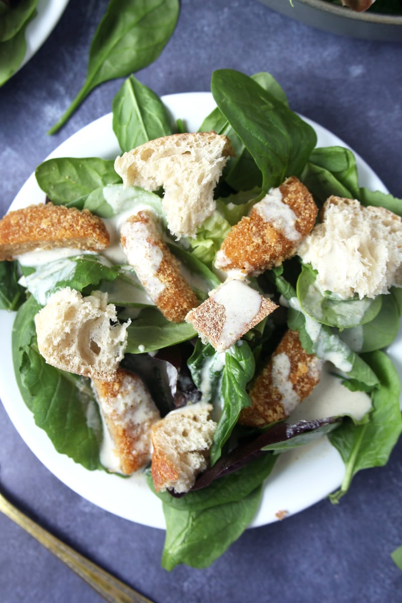 Julius Caesar may not have invented the Caesar salad, but I bet he would love this vegan Caesar salad, which is loaded down with chicken alternative, fresh bread croutons, and a tangy homemade dressing. A snap to make, this salad hits the spot and can be enjoyed any day of the week. #vegancaesarsalad #vegancaesardressing #vegancaesardressingtahini #veganchickencaesarsalad #veganchickencaesar #bohemianvegankitchen 