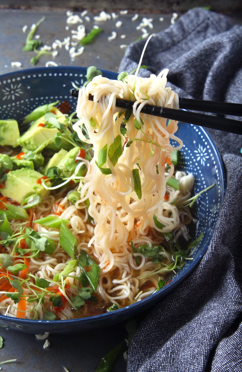 Don't have time for a fancy dinner? No problem! Try this FAST vegan ramen noodle bowl, which takes just under 15 minutes to make! Using delicious + fresh toppings like carrots, avocado, cilantro, and green onions, you'll have a killer dinner that everyone will enjoy! #quickvegandinner #quickvegandinnereasy #quickvegandinnerhealthy #veganramennoodlerecipes #veganrameneasy #vegandinnereasy #bohemianvegankitchen 