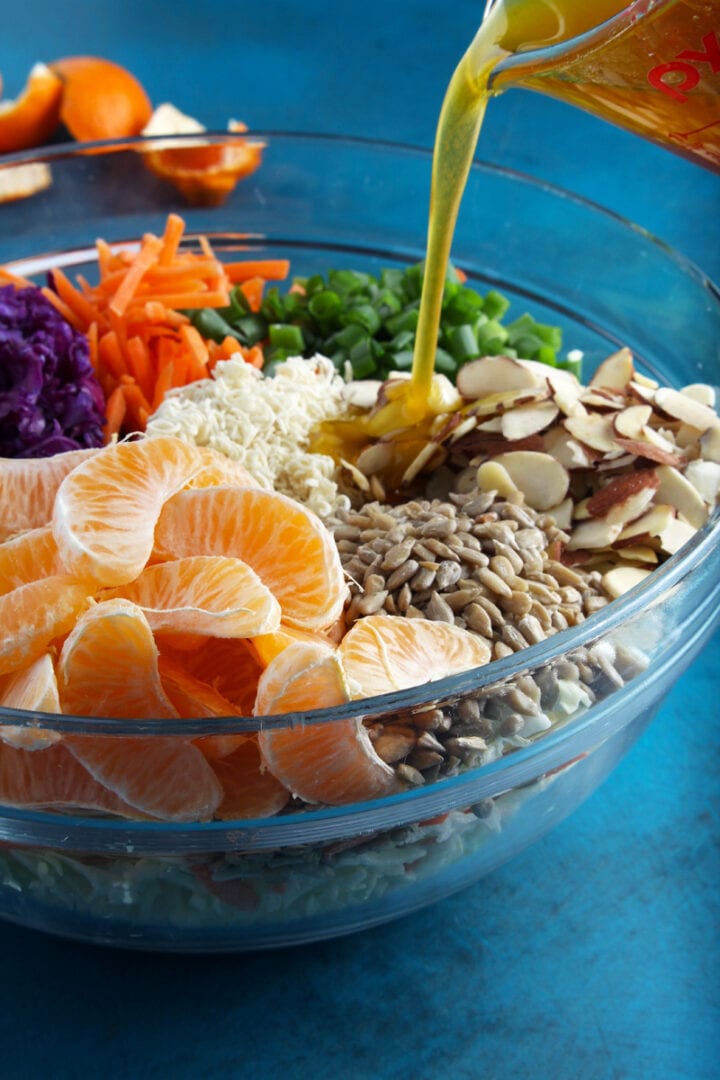 picture of ramen noodle salad with dressing being drizzled on top