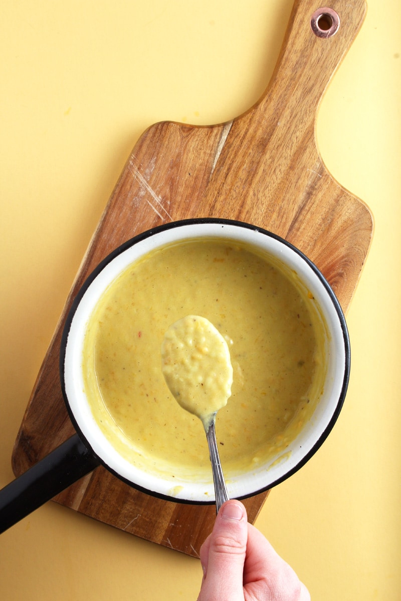 picture of dairy-free cheese sauce with spoon.