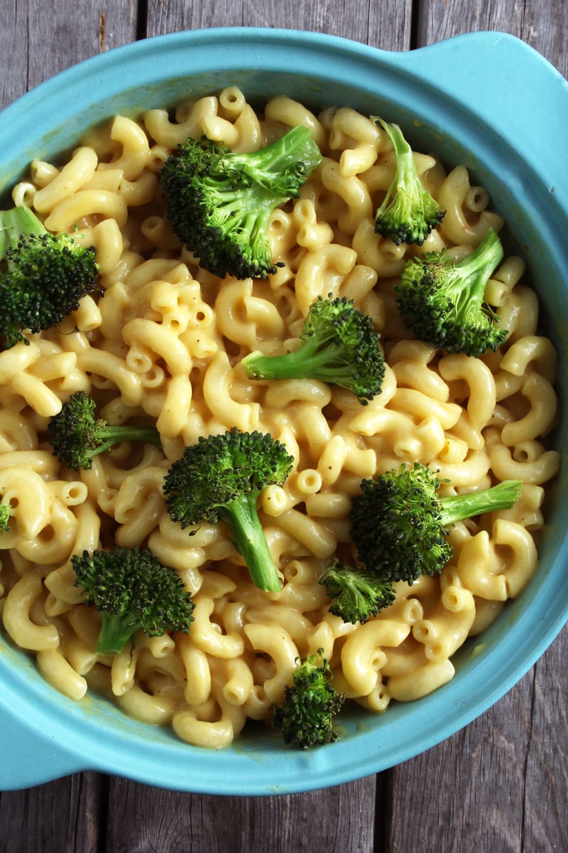 close up of vegan mac and cheese with baked broccoli on top