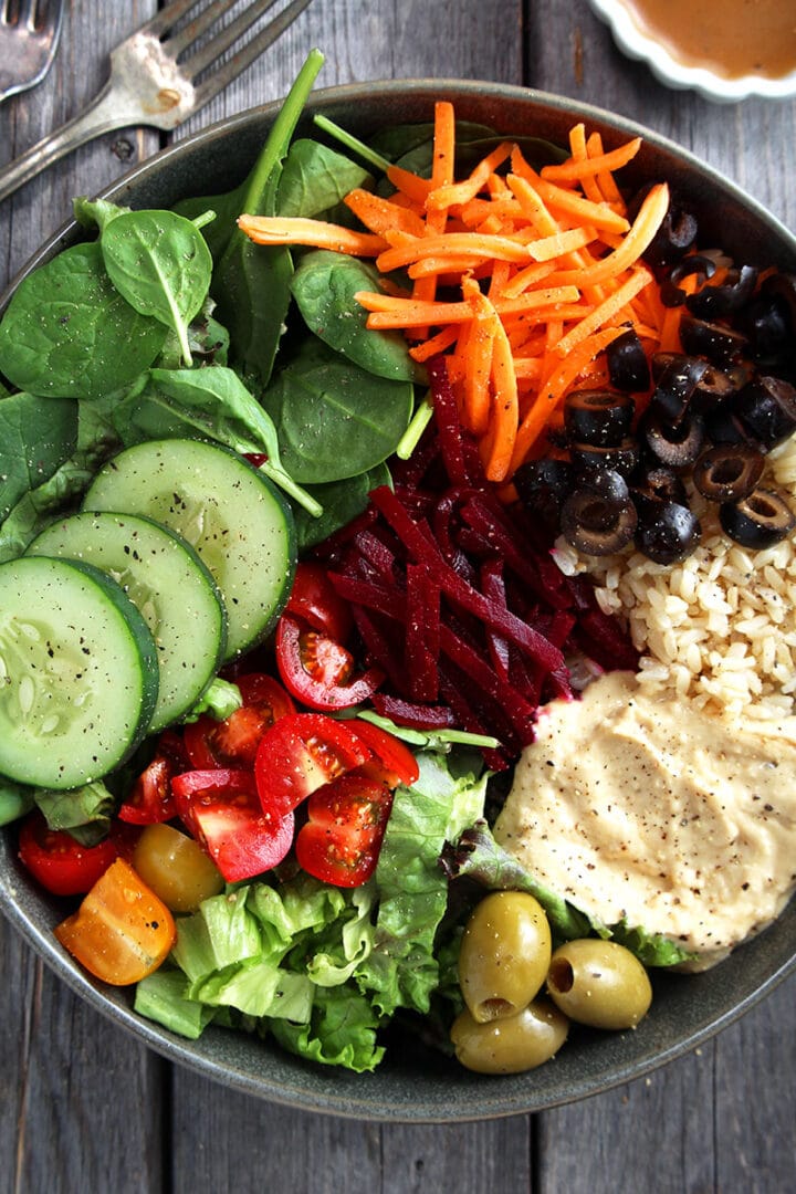 close up of all the veggies that go into a Greek bowl