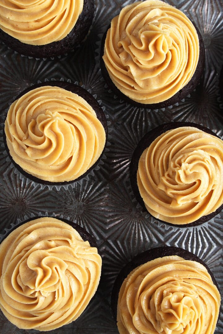 overhead picture of vegan chocolate cupcakes with peanut butter frosting swirled on top