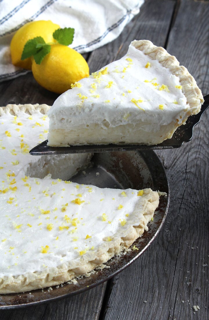 picture of a slice of vegan lemon pie being lifted out of the pie dish