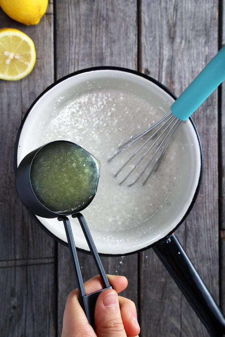 lemon juice being poured into a pan with the other ingredients. 