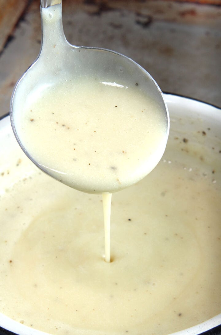 picture of vegan gravy being drizzled into a pan