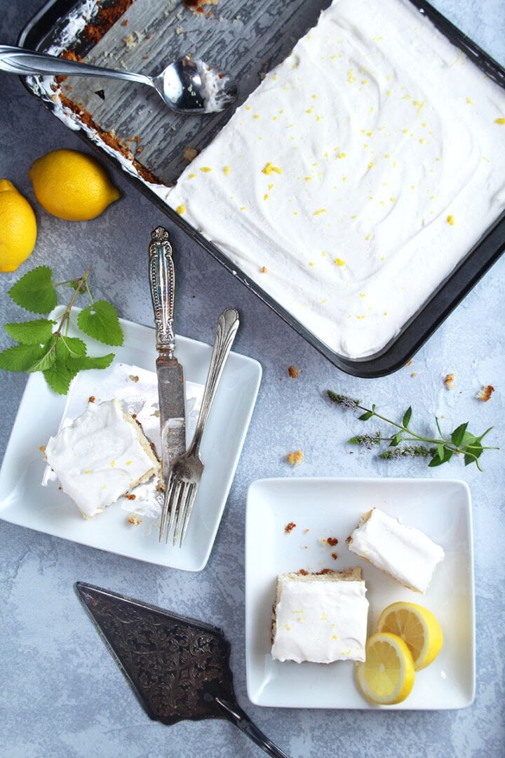 overhead picture of vegan lemon cake, sliced and on two plates 