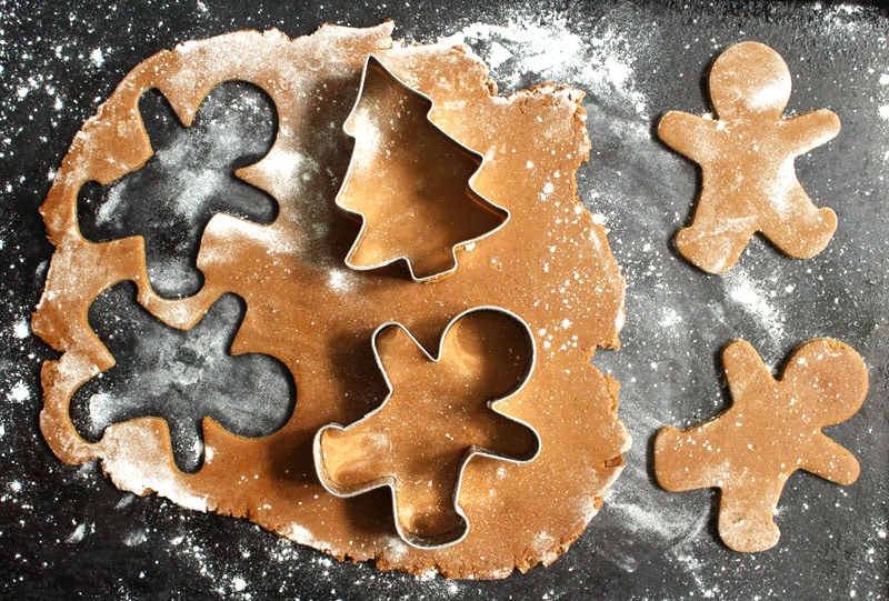 picture of the gingerbread dough, rolled out and pressed with cookie cutters 