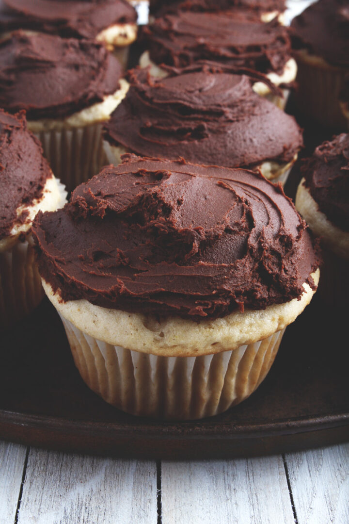 a close up of a cupcake with chocolate ganache frosting on top 
